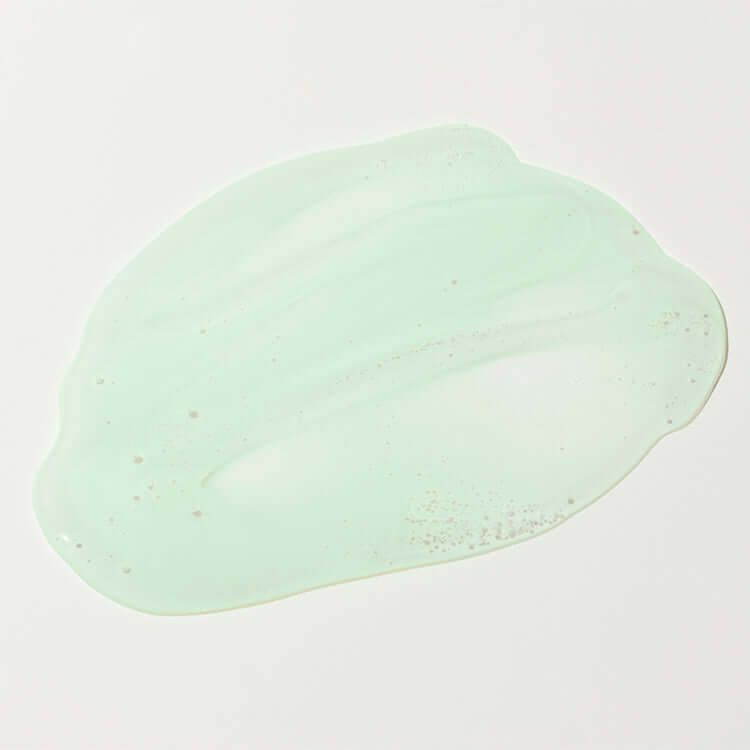 Close-up of pale green gel texture of Bidalli Vegan Hyaluronic Pure Cica Serum spread on white background