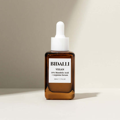 Bidalli 10% Mandelic Acid + Arginine Serum in amber glass bottle with dropper cap - vegan exfoliating serum for sensitive skin, photographed in soft natural light