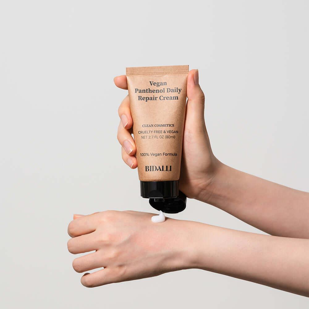 Applying Bidalli Vegan Panthenol Daily Repair Cream onto the hand to show the cream texture and smooth application