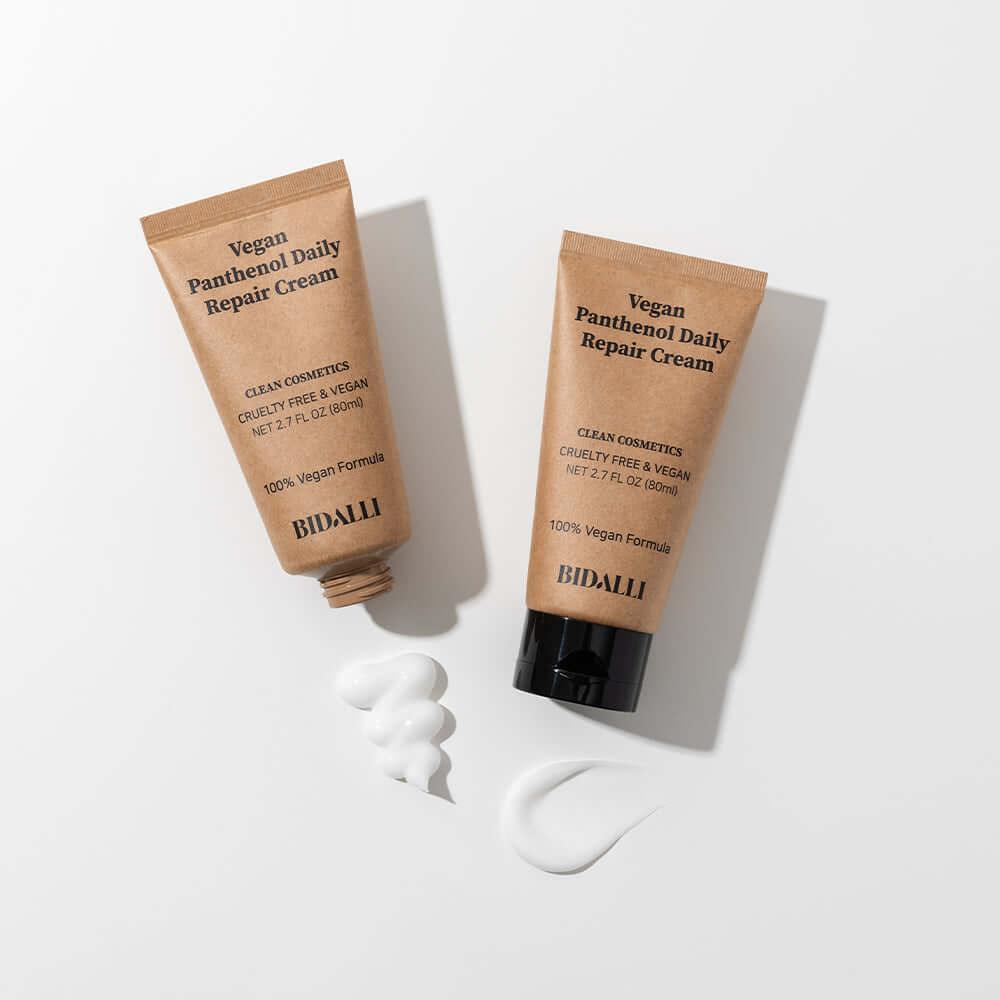 Two BIDALLI Vegan Panthenol Daily Repair Cream tubes with visible cream textures on a white surface, showcasing the product&
