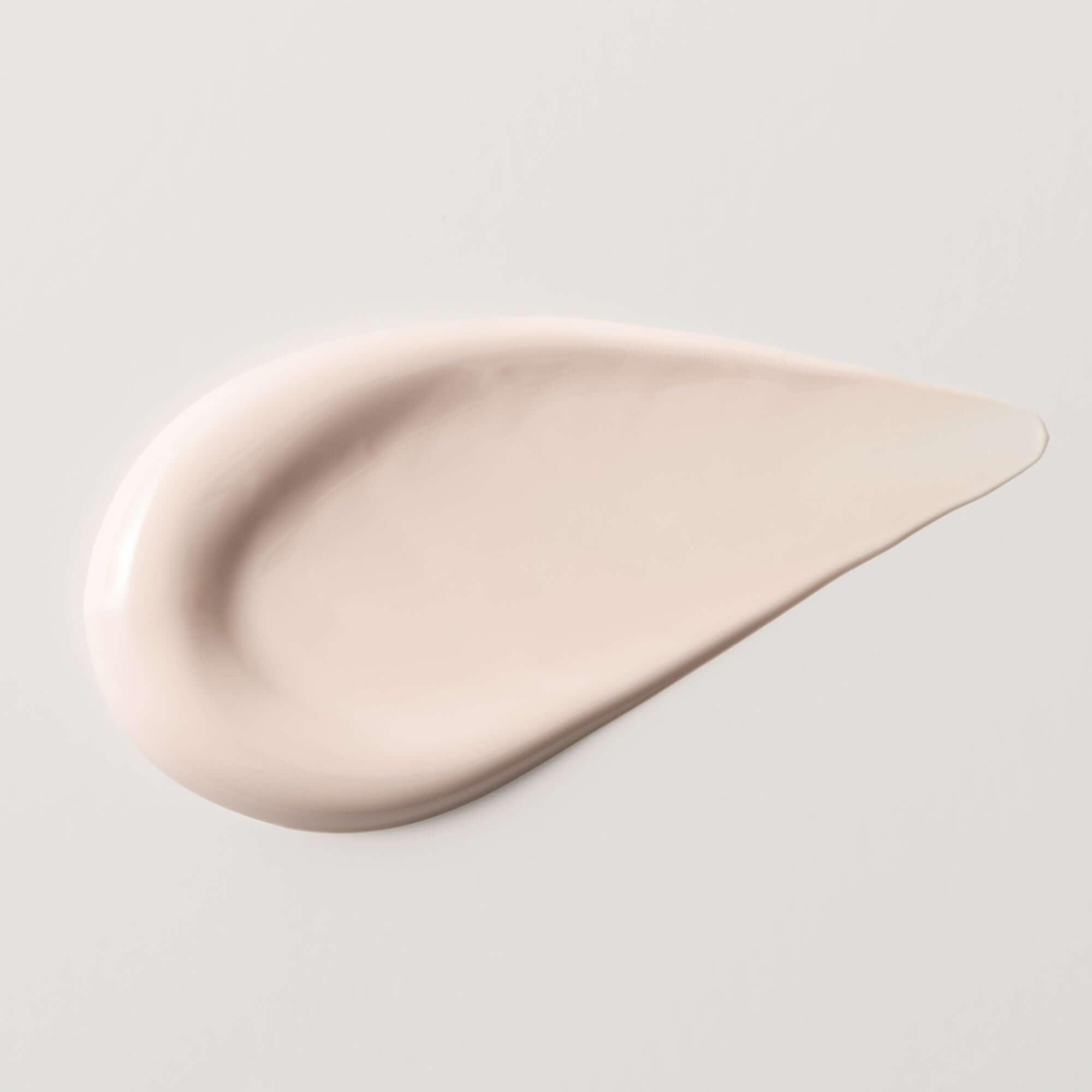Close-up of Bidalli Vegan Tone Up VitaC Glow Sun Lotion creamy pink texture, lightweight tone-up sunscreen with brightening finish for radiant skin