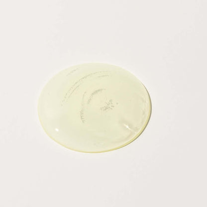 Close-up of transparent yellow serum texture from Bidalli Vegan Tone-Up Pure Vita Serum on white background